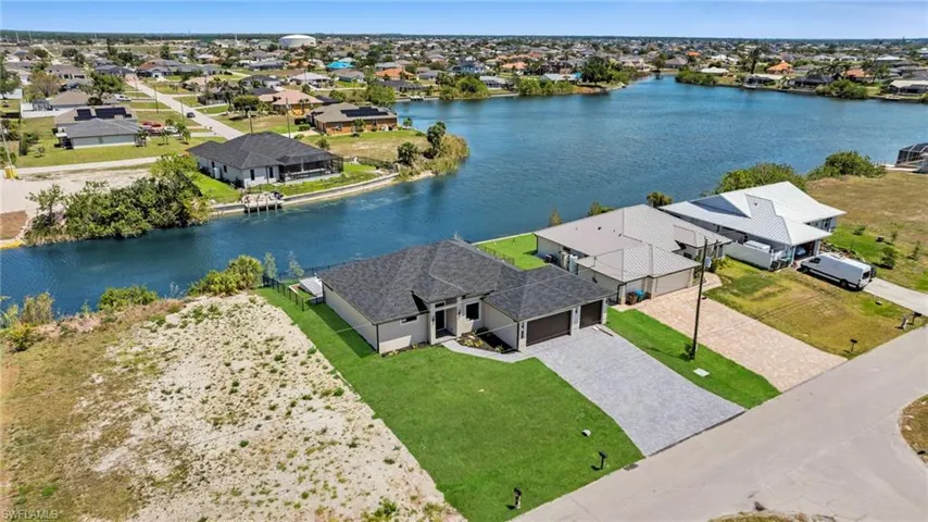 Birds eye view of property with a residential view and a water view