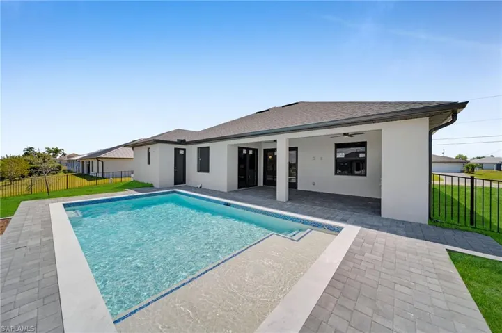 View of swimming pool with a yard, fence, a patio area, and a fenced in pool