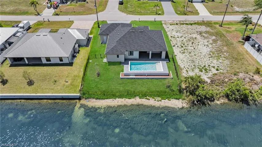 Birds eye view of property featuring a residential view and a water view