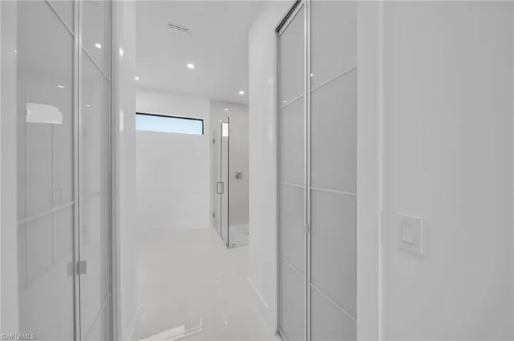 Hallway featuring visible vents and recessed lighting