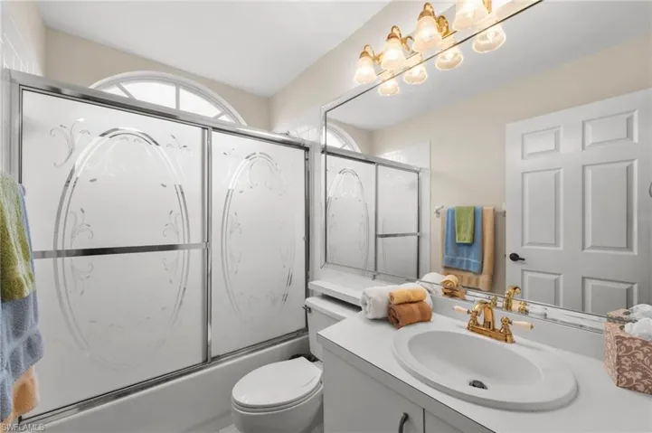 Full bathroom featuring vanity and combined bath / shower with glass door