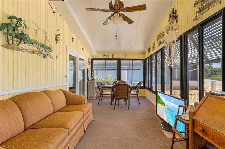 Sunroom featuring vaulted ceiling and ceiling fan