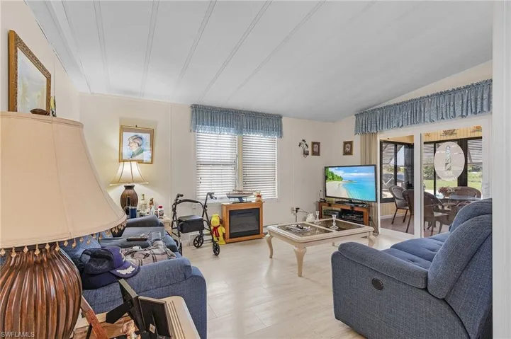 Living room featuring lofted ceiling