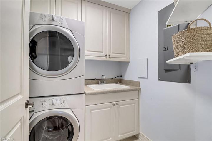 Upstairs laundry room with stackable washer dryer and utility tub