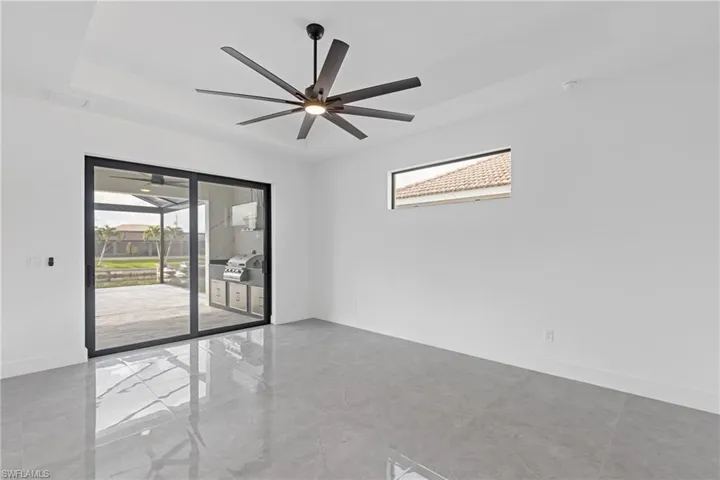 Empty room with ceiling fan and plenty of natural light