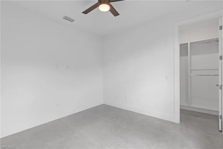 Unfurnished bedroom with a closet and ceiling fan