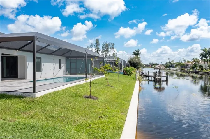 Rear of home featuring sea wall and canal