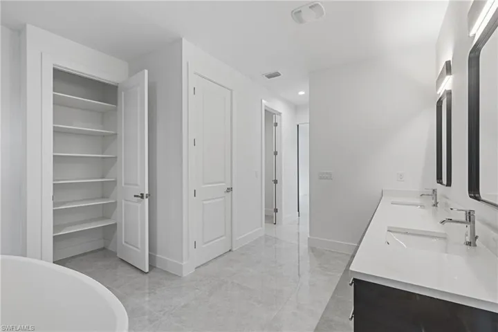 Bathroom with vanity and a washtub