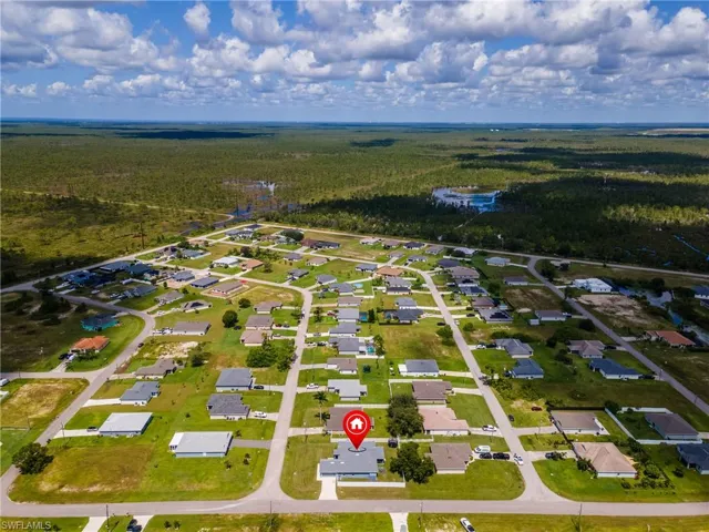 Aerial perspective of suburban area featuring a heavily wooded area