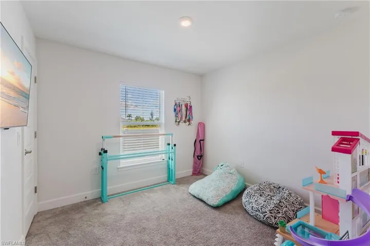 Recreation room with carpet flooring and baseboards
