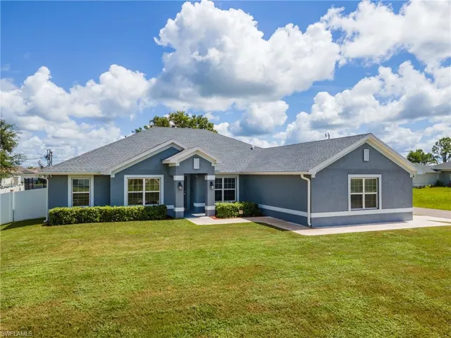 Single story home featuring stucco siding and a shingled roof