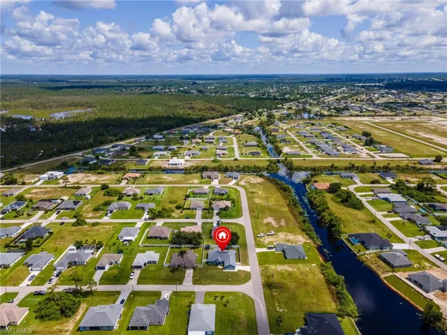 Aerial perspective of suburban area featuring a large body of water