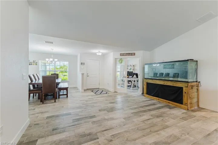 Living room with light wood-style flooring and a chandelier