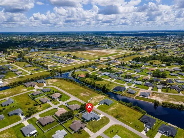 Aerial view of property's location featuring a large body of water and nearby suburban area