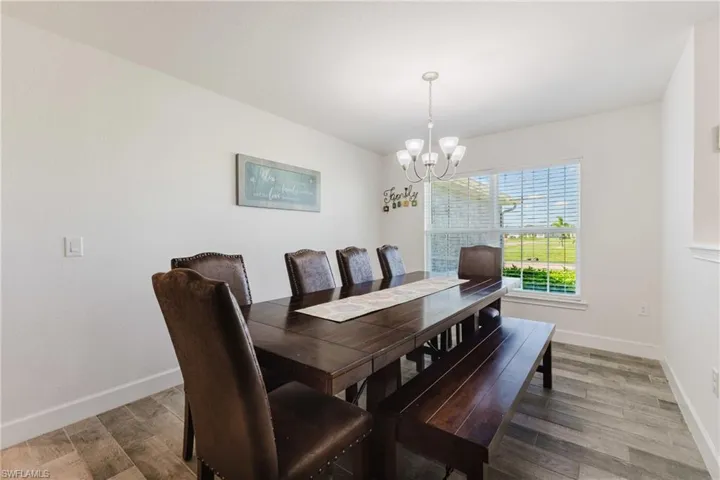 Dining space featuring light wood-type flooring and a chandelier