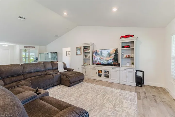 Living area featuring lofted ceiling and light wood finished floors
