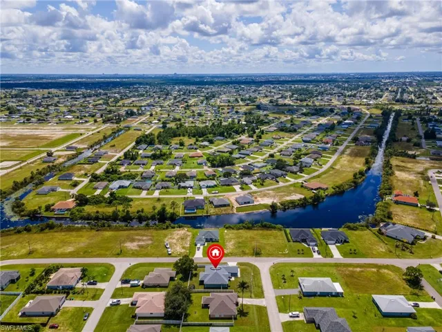 Aerial perspective of suburban area featuring a nearby body of water