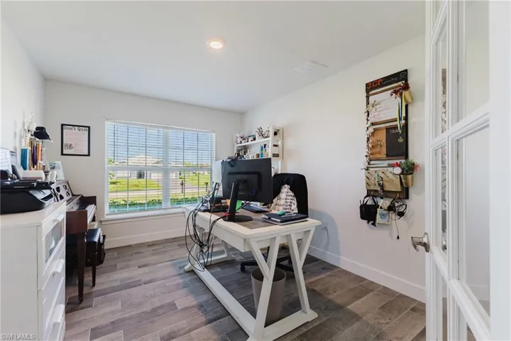 Office area with dark wood-style flooring and recessed lighting