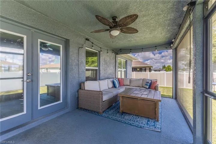Sunroom / solarium featuring french doors, an outdoor living space, and ceiling fan