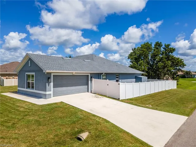 View of home's exterior with a shingled roof, stucco siding, concrete driveway, and a garage