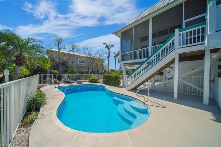 View of swimming pool featuring a patio area and a sunroom