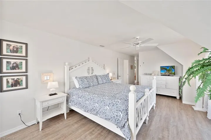 Bedroom featuring wood-type flooring and ceiling fan