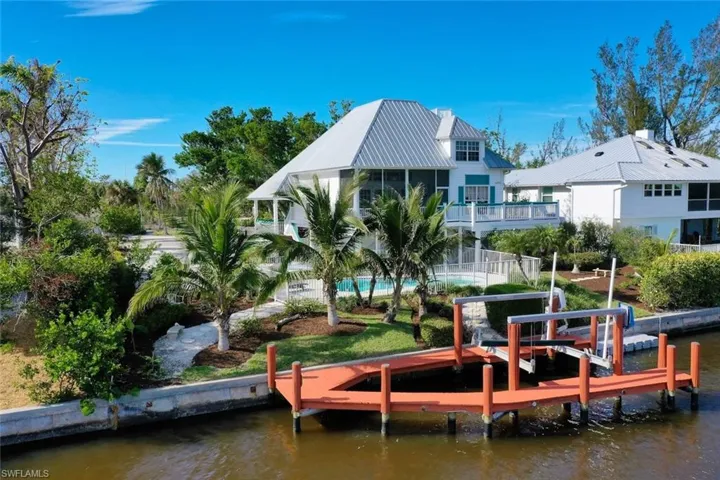 Dock area featuring a balcony and a water view