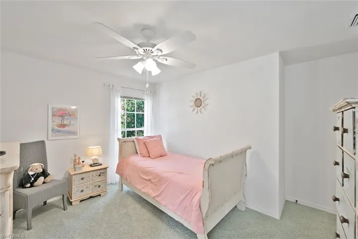 Carpeted bedroom with ceiling fan