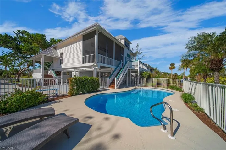 View of swimming pool with a sunroom and a patio area