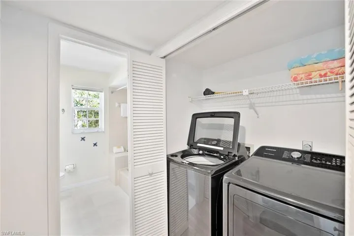 Washroom featuring washing machine and clothes dryer