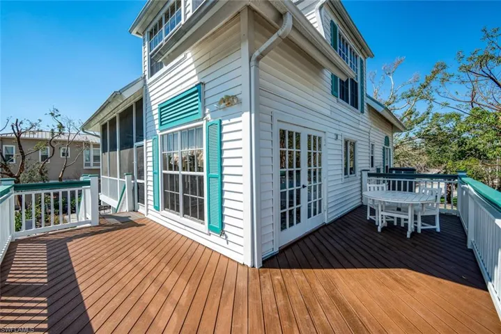 Wooden terrace featuring a sunroom