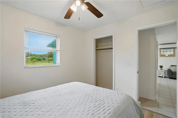 Bedroom featuring ceiling fan, a closet, and light tile patterned floors