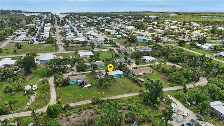 Aerial view of property and surrounding area with nearby suburban area