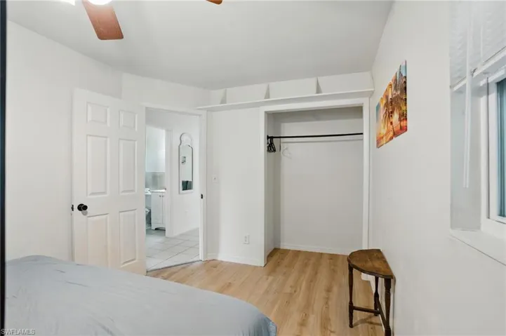 Bedroom featuring light wood-style flooring, a closet, and ceiling fan
