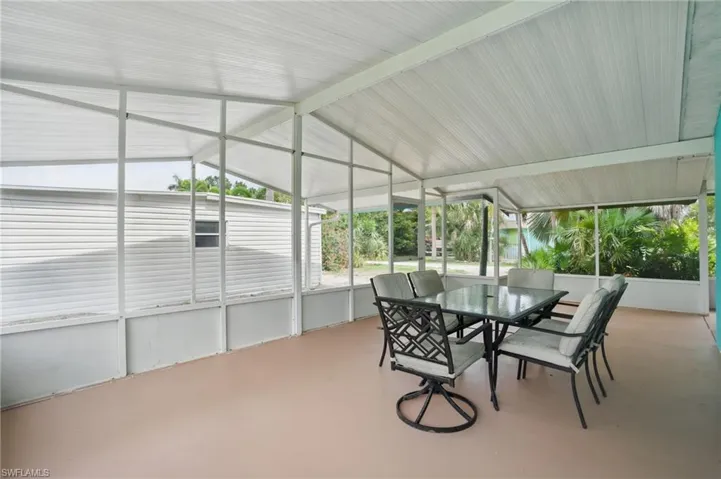Sunroom / solarium featuring outdoor dining space and vaulted ceiling