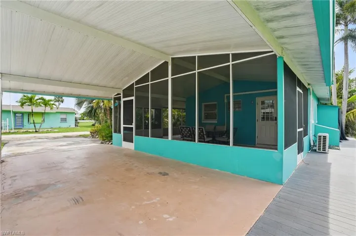 View of patio / terrace featuring a sunroom and a carport