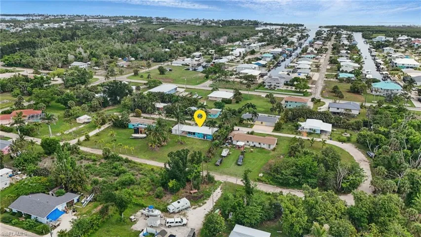 Aerial view of property and surrounding area with nearby suburban area
