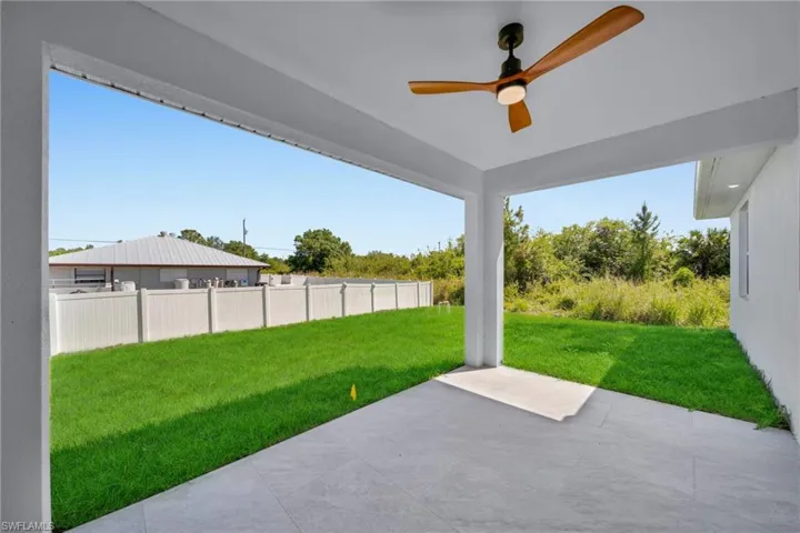 View of yard with a patio and a ceiling fan
