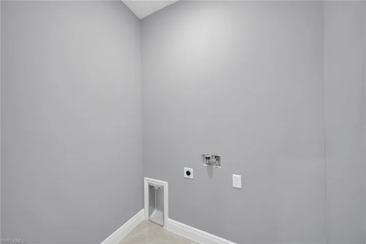Laundry area featuring electric dryer hookup, hookup for a washing machine, and baseboards