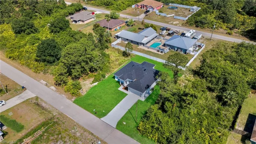 Aerial perspective of suburban area with a pool