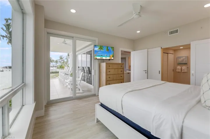 Bedroom with access to exterior, light wood-style floors, ceiling fan, a closet, and recessed lighting