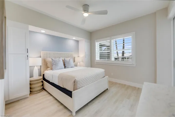 Bedroom featuring light wood finished floors, ceiling fan, and recessed lighting