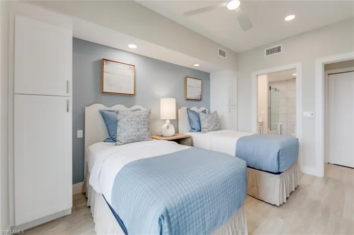 Bedroom featuring recessed lighting, a ceiling fan, light wood-style floors, and ensuite bath