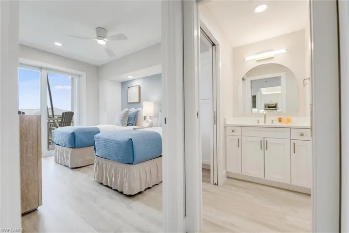 Bedroom with light wood-style floors, recessed lighting, a ceiling fan, and access to exterior