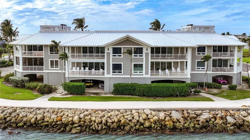 Rear view of house featuring a water view and a metal roof