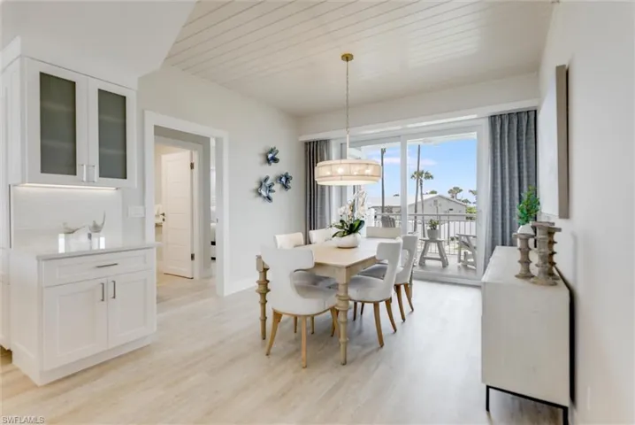 Dining room featuring light wood-style floors and wooden ceiling