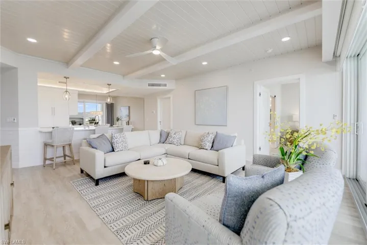 Living room with a ceiling fan, light wood-style floors, a wooden ceiling with exposed beams, and recessed lighting