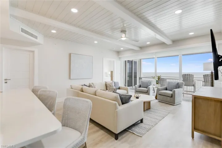 Living area featuring ceiling fan, wood finished floors, a wood ceiling with exposed beams, and recessed lighting