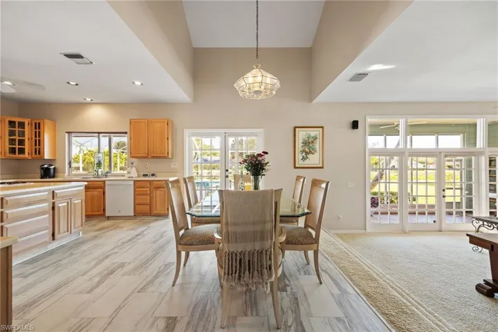 Dining room with French doors, and towering ceiling