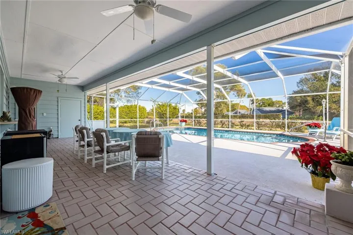 Outdoor pool with a patio, and screened enclosure